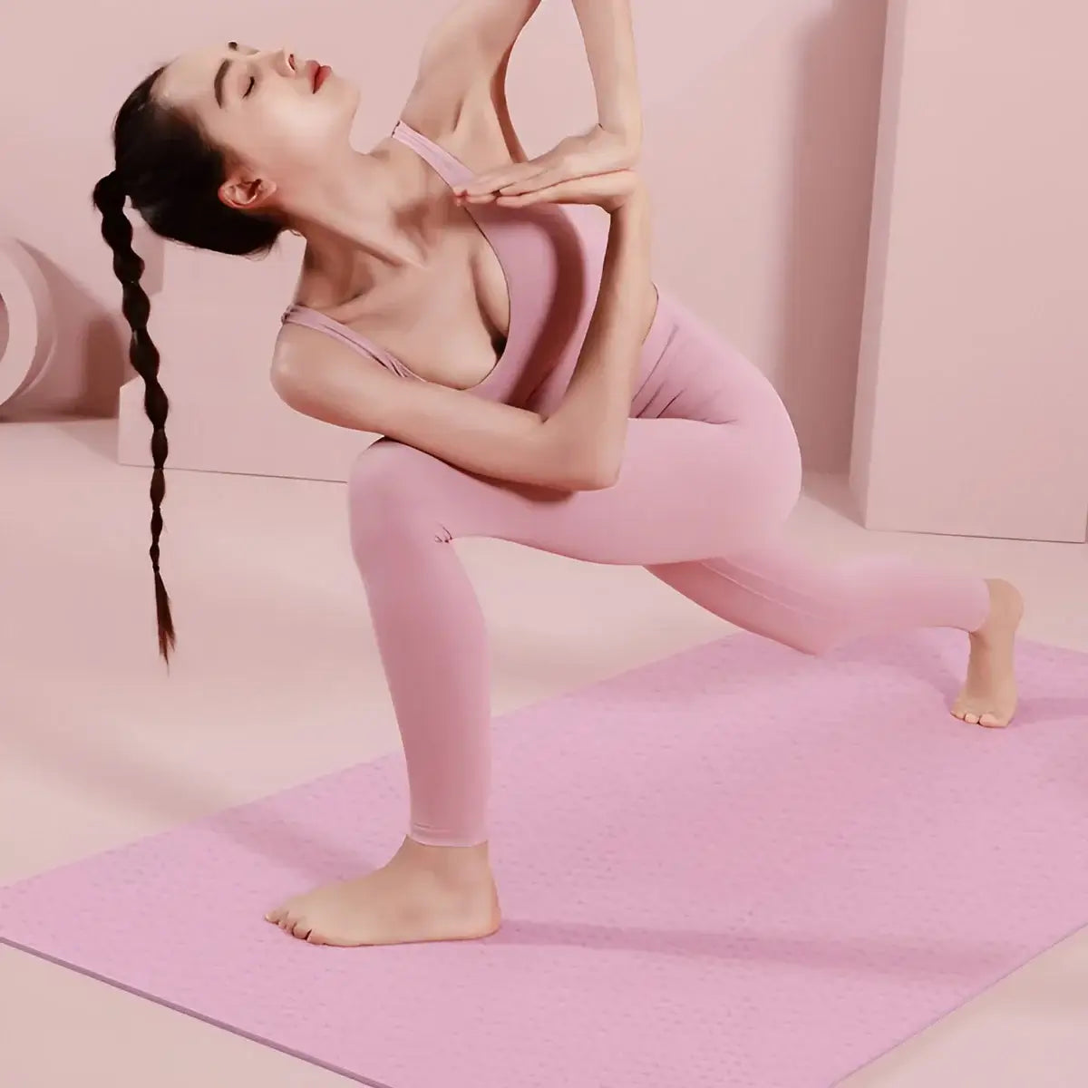 Women Fashion Feather Printed Hoodies model performing yoga on a pink mat, showcasing fitness and style.