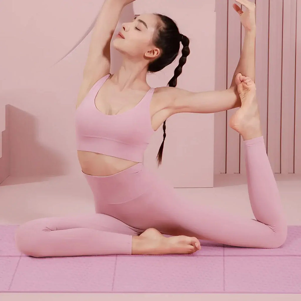Women Fashion Feather Printed Hoodies worn by a woman practicing yoga on a pink mat.